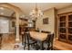 Dining room with wooden table, stylish chairs, and seamless flow to the adjacent kitchen for easy entertaining at 12539 Pebblepointe Pass, Carmel, IN 46033