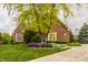 Attractive brick home showcasing vibrant landscaping and a well-maintained front yard at 12539 Pebblepointe Pass, Carmel, IN 46033