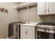 Laundry room featuring stainless steel washer and dryer at 12539 Pebblepointe Pass, Carmel, IN 46033