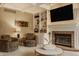 Inviting living room features a brick fireplace, custom built-ins, recessed lights, and cozy seating for relaxing and entertaining at 12539 Pebblepointe Pass, Carmel, IN 46033