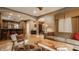Open-concept living room with hardwood floors, an inviting sofa, stylish chairs, and seamless flow to kitchen and dining areas at 12539 Pebblepointe Pass, Carmel, IN 46033