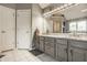 Bathroom with a large vanity with double sinks, a large mirror and tile flooring at 12539 Pebblepointe Pass, Carmel, IN 46033