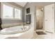 Main bathroom features a soaking tub, walk-in shower and abundant natural light at 12539 Pebblepointe Pass, Carmel, IN 46033