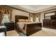 Spacious main bedroom suite featuring a large bed, tray ceiling and neutral décor at 12539 Pebblepointe Pass, Carmel, IN 46033