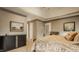 Comfortable main bedroom with a large bed, dresser, and neutral color scheme at 12539 Pebblepointe Pass, Carmel, IN 46033