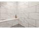 Shower showcasing sleek white marble-look tile and a built-in corner seat at 12539 Pebblepointe Pass, Carmel, IN 46033