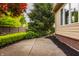 Charming side yard showcasing lush landscaping and a serene walkway alongside the home's exterior at 12539 Pebblepointe Pass, Carmel, IN 46033