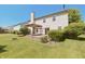 View of the home's backyard featuring a lawn, deck with pergola, and mature shrubbery at 12677 Honors Dr, Carmel, IN 46033