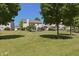 View of the home's backyard featuring a large lawn, trampoline and mature trees at 12677 Honors Dr, Carmel, IN 46033