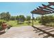 Expansive backyard featuring a deck, firepit, trampoline, and lush green lawn at 12677 Honors Dr, Carmel, IN 46033
