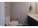 Bathroom featuring a toilet and a single sink vanity with mirror, towel rack, and yellow flower at 12677 Honors Dr, Carmel, IN 46033
