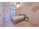 Bedroom featuring a grey bed frame, ceiling fan, window with curtains, and unicorn artwork at 12677 Honors Dr, Carmel, IN 46033