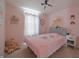 Pink bedroom with a cute bed, decor, and carpeted floors at 12677 Honors Dr, Carmel, IN 46033