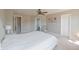 Bright bedroom with a ceiling fan, natural light, carpeted floors and a light color palette at 12677 Honors Dr, Carmel, IN 46033