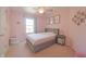 Pink bedroom featuring a grey bed frame, ceiling fan, window, and unicorn artwork at 12677 Honors Dr, Carmel, IN 46033