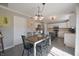 Cozy dining area adjacent to the kitchen, featuring modern lighting and ample seating at 12677 Honors Dr, Carmel, IN 46033