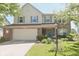 Charming two-story home with a brick facade, attached garage, and well-manicured lawn at 12677 Honors Dr, Carmel, IN 46033
