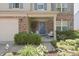 Inviting front porch with blue door, stylish seating, and charming landscaping at 12677 Honors Dr, Carmel, IN 46033