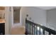 Upstairs hallway with carpeted floors, neutral paint, and black railing at 12677 Honors Dr, Carmel, IN 46033