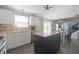 Well-lit kitchen features white cabinets, stainless steel appliances, an island, and sliding glass doors at 12677 Honors Dr, Carmel, IN 46033
