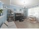 Cozy living space with a blue accent wall, featuring a piano and natural light at 12677 Honors Dr, Carmel, IN 46033