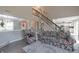 Inviting living room featuring floral sofa, staircase, and open access to the kitchen at 12677 Honors Dr, Carmel, IN 46033