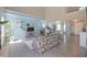 Bright living room boasts high ceilings, floral sofa, and a large plant, filled with natural light at 12677 Honors Dr, Carmel, IN 46033