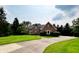 Beautiful brick home boasting lush landscaping, a curved driveway, and a charming architectural design at 12854 Northants Cir, Carmel, IN 46032
