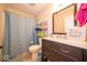 Cozy bathroom featuring a framed mirror, vanity with storage and shower with curtain at 13911 Naples Dr, Fishers, IN 46038
