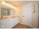A bathroom with a double sink vanity, modern lighting, and a framed mirror at 13911 Naples Dr, Fishers, IN 46038