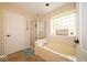 This bathroom has a bathtub, glass enclosed shower and a beautiful window at 13911 Naples Dr, Fishers, IN 46038