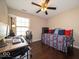 A bedroom features a hardwood floor, desk, daybed and ceiling fan at 13911 Naples Dr, Fishers, IN 46038