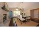 Elegant dining room featuring a fireplace, chandelier, and ample natural light at 13911 Naples Dr, Fishers, IN 46038