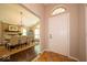 Warm entryway leading to a dining room with a fireplace and chandelier at 13911 Naples Dr, Fishers, IN 46038