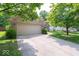 Charming brick home with a well-manicured lawn, mature trees, and an attached two-car garage at 13911 Naples Dr, Fishers, IN 46038