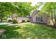 Charming brick home with a well-manicured lawn, mature trees, and an attached two-car garage at 13911 Naples Dr, Fishers, IN 46038