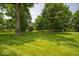 Beautiful park-like setting with mature trees and green grass at 13911 Naples Dr, Fishers, IN 46038