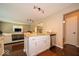Well-lit kitchen with an island, stainless steel dishwasher and hardwood floors at 13911 Naples Dr, Fishers, IN 46038