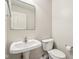 Simple half bathroom featuring a pedestal sink and toilet at 14036 Rayners Ln, Fishers, IN 46037