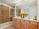 Bright bathroom featuring a glass shower, double vanity with countertop, and a large mirror at 14036 Rayners Ln, Fishers, IN 46037