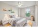 Cozy bedroom with a ceiling fan, window views, neutral-toned decor, and plush bedding at 14036 Rayners Ln, Fishers, IN 46037