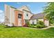 Charming two-story home featuring a manicured lawn and brick accents at 14036 Rayners Ln, Fishers, IN 46037