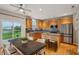 Modern kitchen featuring stainless steel appliances, wooden cabinets, and a large island at 14036 Rayners Ln, Fishers, IN 46037