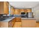 Well-equipped kitchen with wooden cabinets, stainless steel appliances, and ample counter space at 14036 Rayners Ln, Fishers, IN 46037