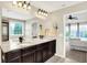 Bathroom with dual sinks, dark wood cabinets, granite counters, and access to ensuite at 14499 Milton Rd, Fishers, IN 46037