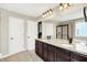 Bathroom vanity with double sinks, granite counters, large mirror and modern fixtures at 14499 Milton Rd, Fishers, IN 46037