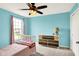 Bedroom with large window providing natural light and a colorful dresser at 14499 Milton Rd, Fishers, IN 46037