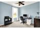 Bedroom with light blue walls, ceiling fan, carpeted floors, and bright natural light at 14499 Milton Rd, Fishers, IN 46037