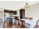 A kitchen with dark cabinetry and stainless appliances adjacent to a dining area at 14499 Milton Rd, Fishers, IN 46037