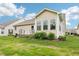 Well-maintained backyard with a deck, green grass, landscaping, and inviting outdoor space at 1468 Blackthorne N Trl, Plainfield, IN 46168